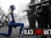 Here’s Why This Pic Of An African-American Woman Kneeling In Front Of Armed Policemen Is So Significant