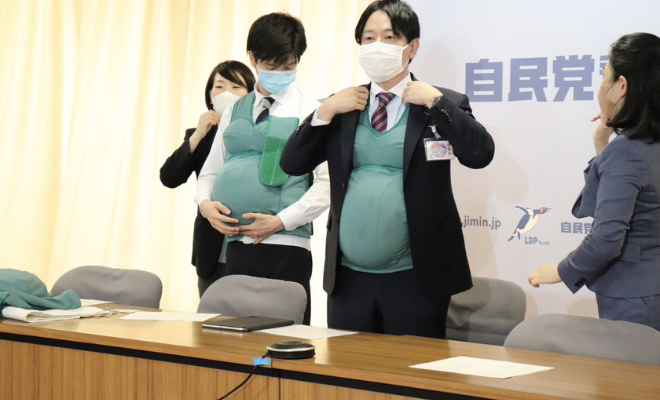 Japanese Minister Masanobu Ogura Tries On Pregnancy Belly To Understand The Declining Birth Rate. This Is Interesting!