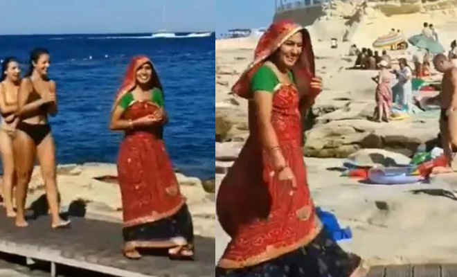 Indian Woman Flaunts Her Elegant Saree While Strolling On The Beach Among Foreigners. Desi Representation Matters!